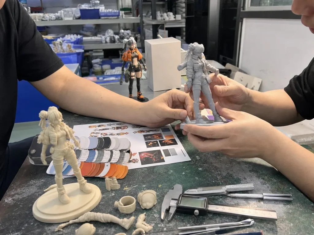 Custom figure prototype sample review on a factory workbench