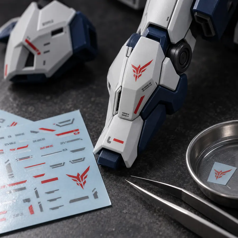 Decal application materials and model part on a workbench for custom product finishing
